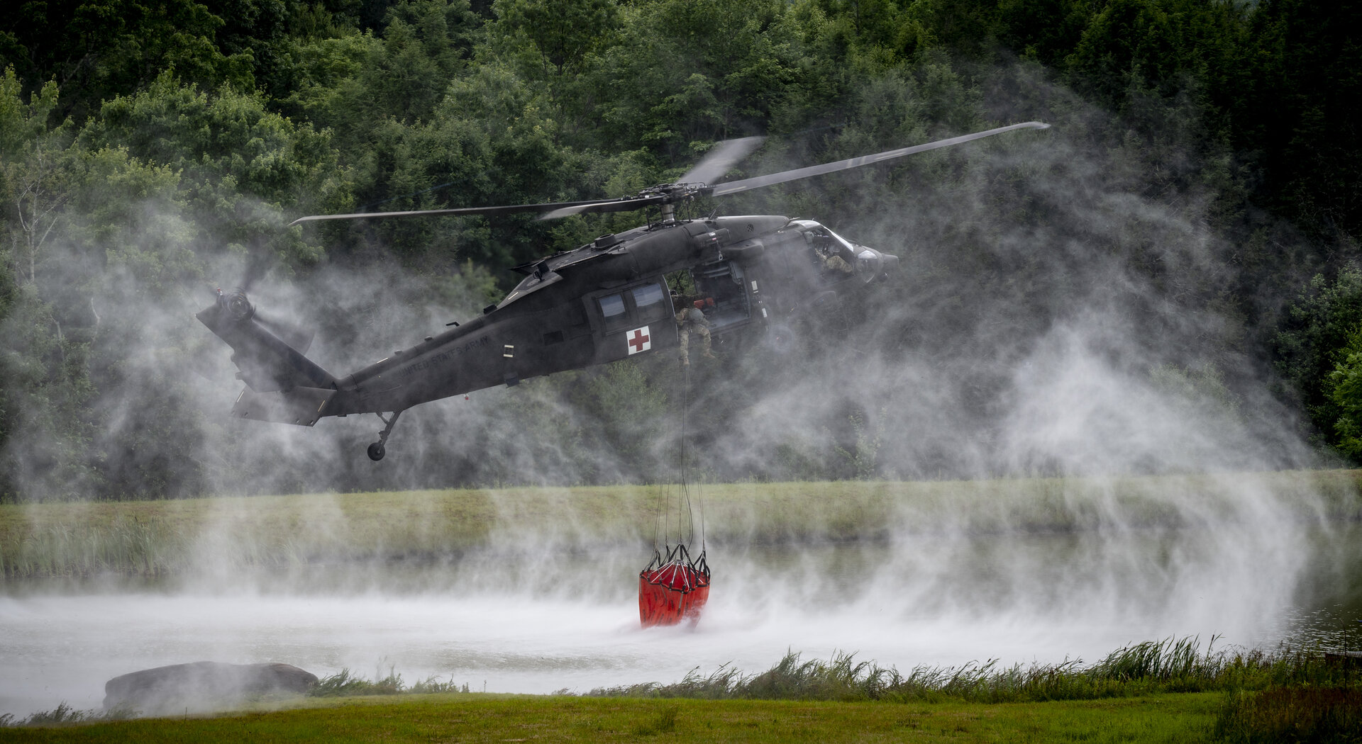 Aerial firefighting helicopter operating over a wildfire response area
