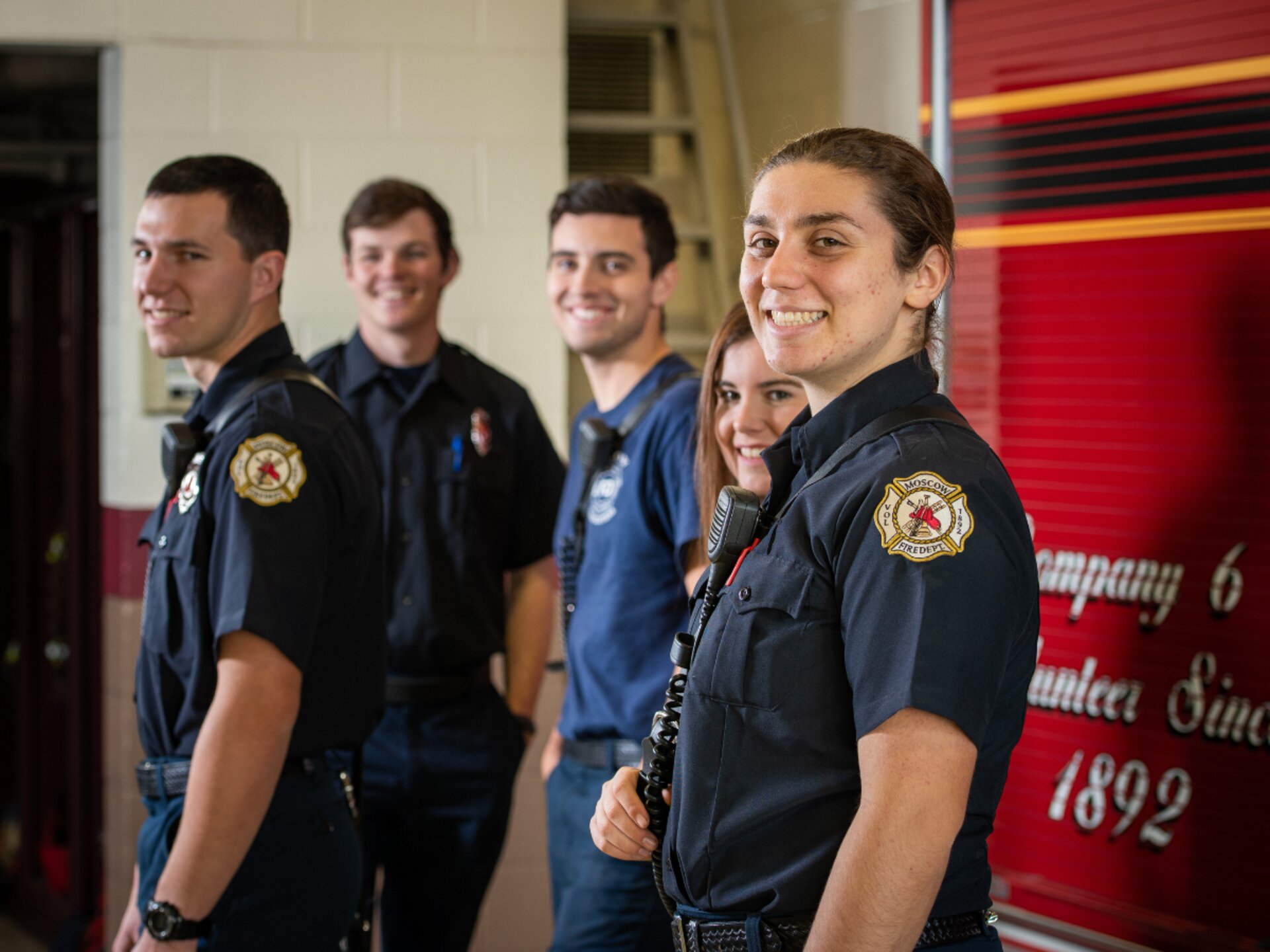 American volunteer firefighters in front of a fire engine