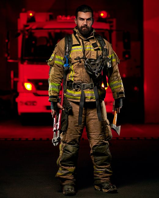 Firefighter in full protective gear with visible gear soiling