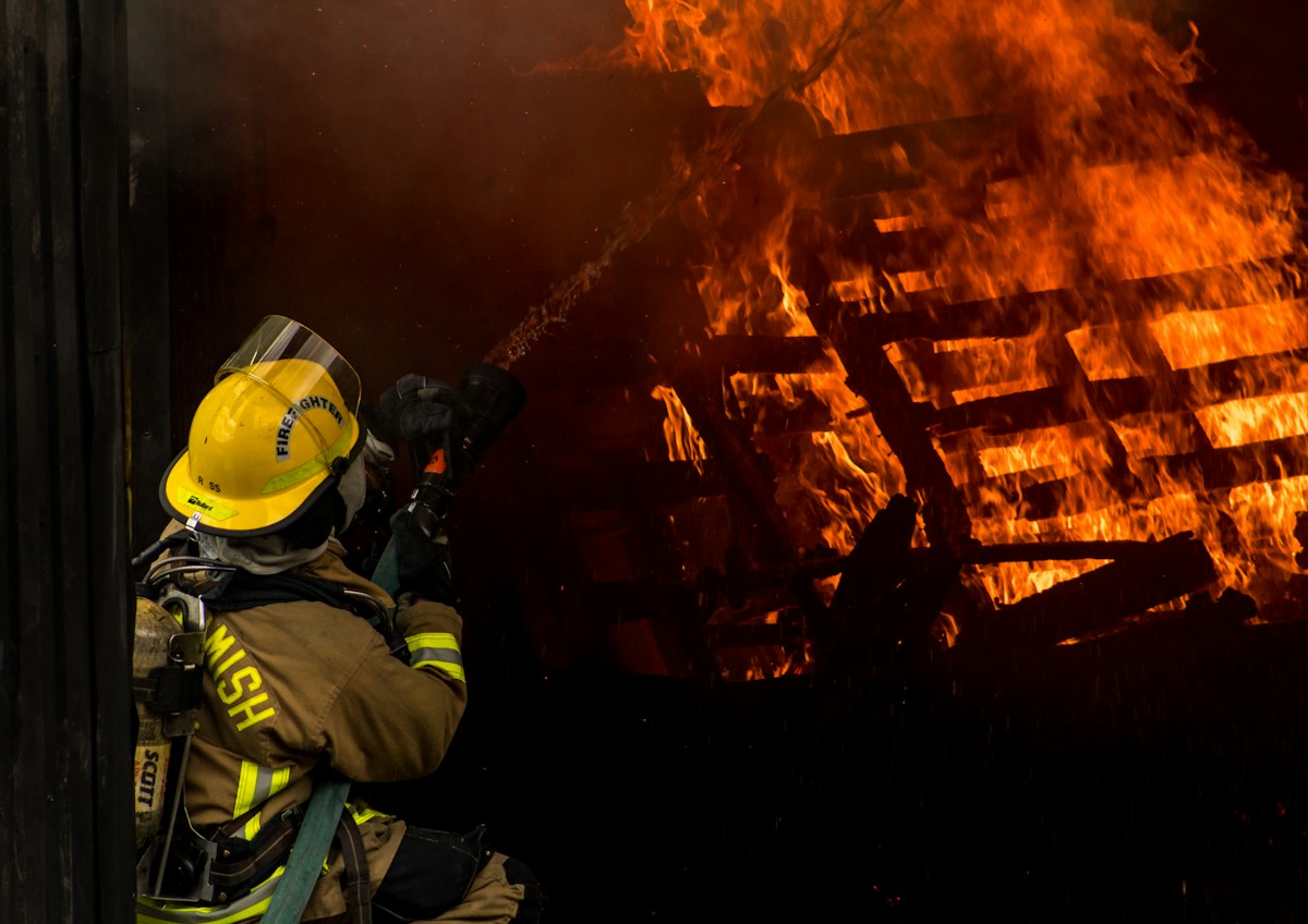 Firefighters working inside a burning shipping container during a live training exercise