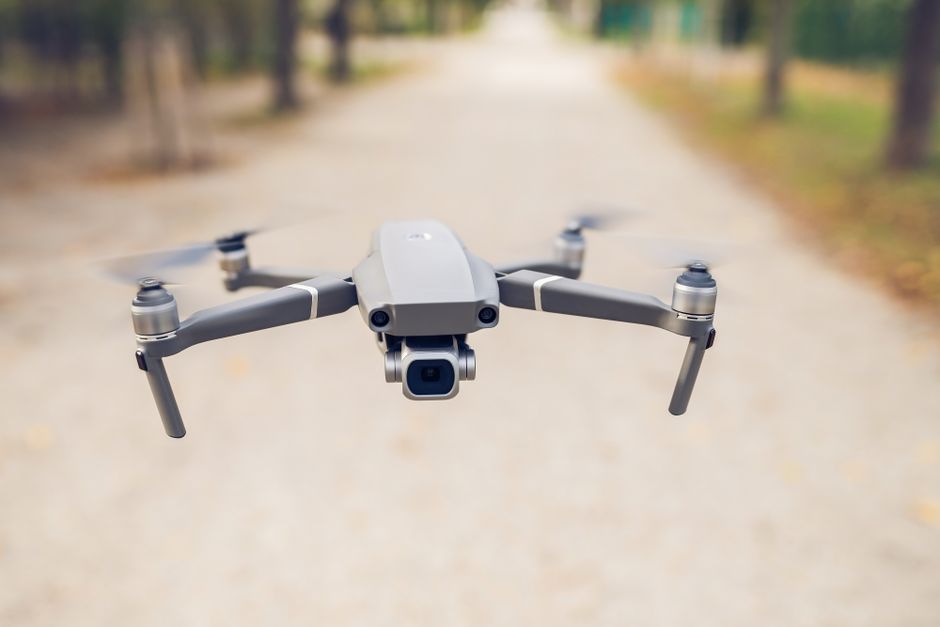 A sleek modern drone flying outdoors